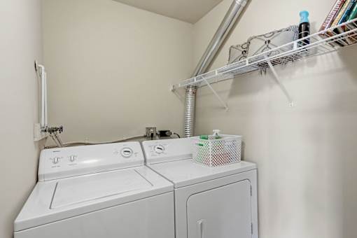 A white washing machine and dryer in a small laundry room.