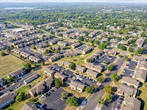 an aerial view of a neighborhood with cars parked in a parking lot