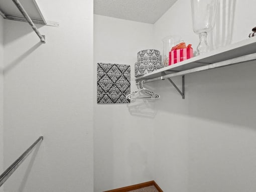 a white bathroom with a shelf in the wall