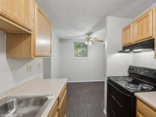 apartment kitchen with a stove and a sink