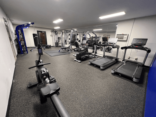 a spacious fitness center with treadmills and other exercise equipment