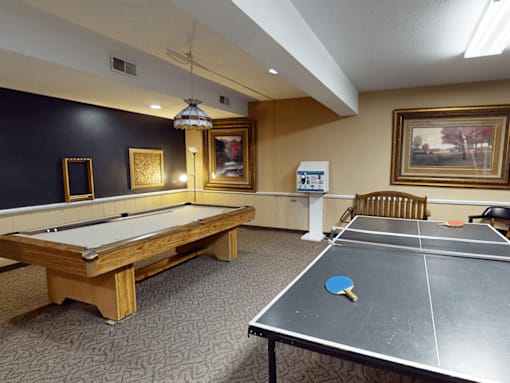 A room with a pool table and a ping pong table.