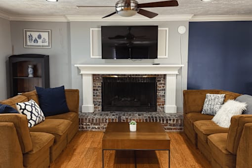 A clubhouse with a fireplace and a television.