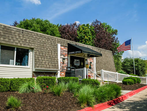 a brick building with an american flag in front of it