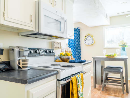 a kitchen with microwave and a stove top oven