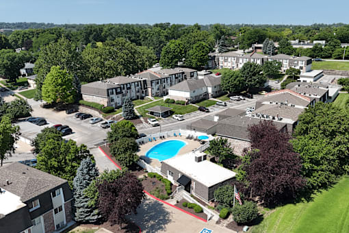 An aerial view of a residential complex with a swimming pool.
