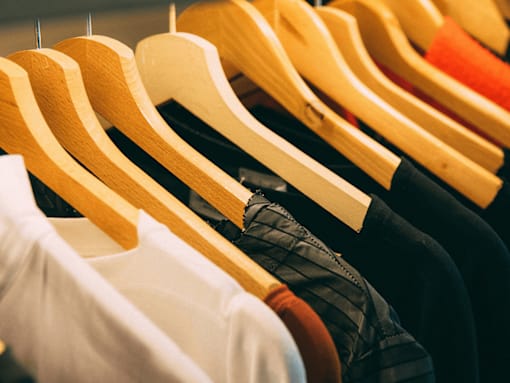 Clothes hanging on wooden hangers.