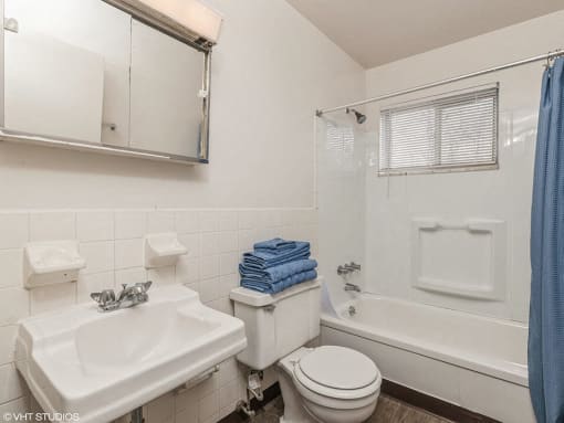 a bathroom with a sink toilet and a tub