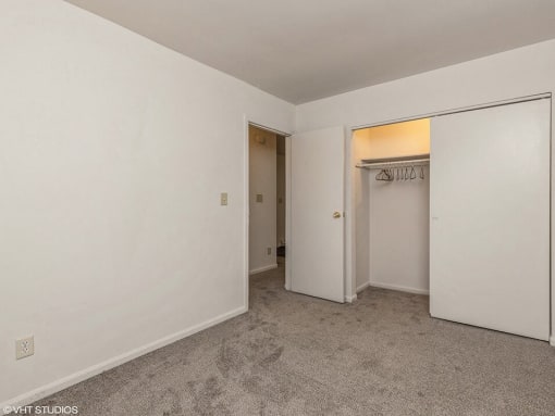 a bedroom with a closet and a door to a closet