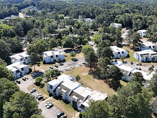 A bird's eye view of a residential area with houses and cars.