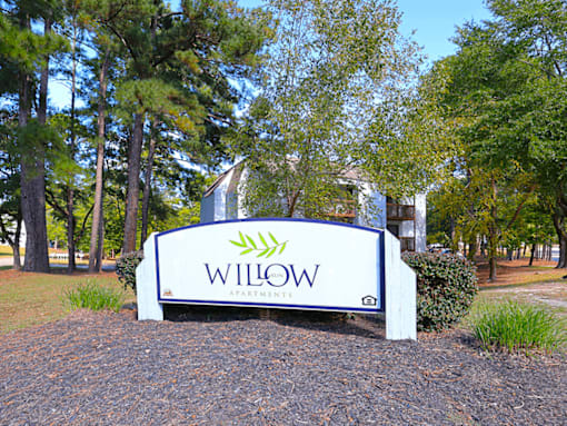 A sign that says Willow in front of a building.
