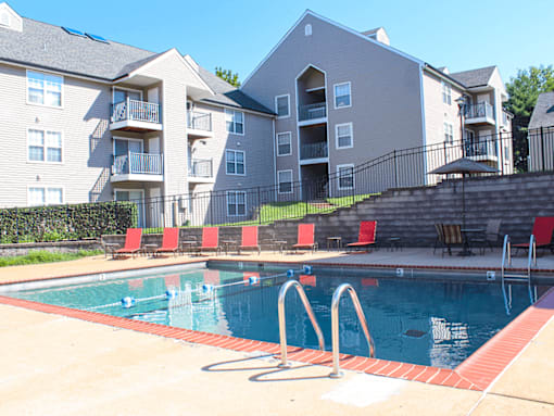 A swimming pool in front of apartment buildings.