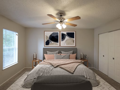 a bedroom with a ceiling fan and a bed