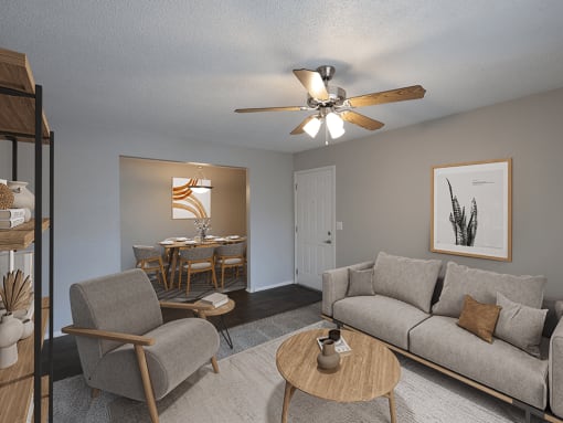 an open living room and dining room with a ceiling fan