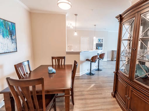 A dining room with a wooden table and chairs.