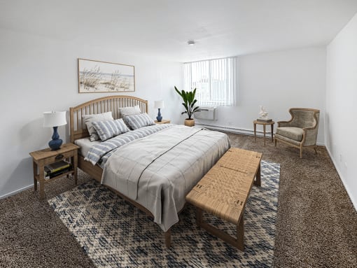 a bedroom with a bed and a chair