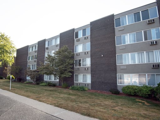 an apartment building on the side of a sidewalk