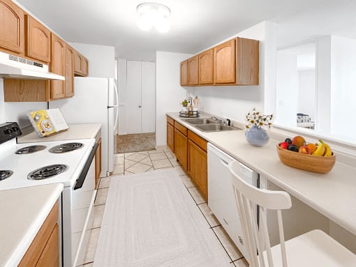 a kitchen with white appliances and wooden cabinets