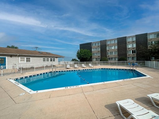a swimming pool in front of an apartment building