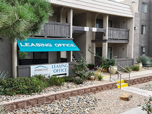 A leasing office sign is displayed in front of a building.
