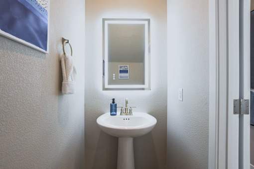 A bathroom with a sink and mirror.at Copper Creek Apartments, Nevada, 89123
