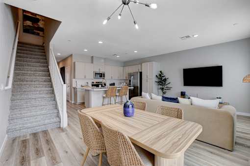 A modern dining room with a wooden table and chairs.at Copper Creek Apartments, Las Vegas, 89123