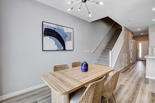 A dining room with a wooden table and chairs.at Copper Creek Apartments, Las Vegas