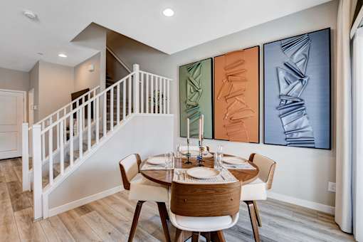 A dining room with a wooden table and chairs.at Copper Creek Apartments, Las Vegas