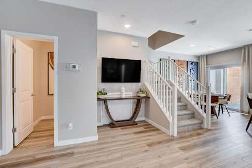A living room with a staircase leading to the upper floor.at Copper Creek Apartments, Nevada
