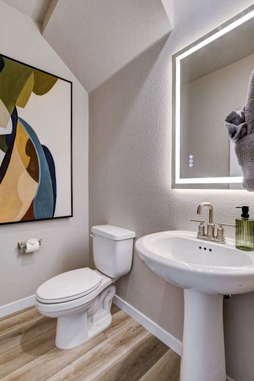 A white toilet and sink in a bathroom. at Copper Creek Apartments, Nevada, 89123