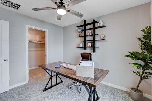 A room with a table, chairs, and a ceiling fan.at Copper Creek Apartments, Las Vegas, NV