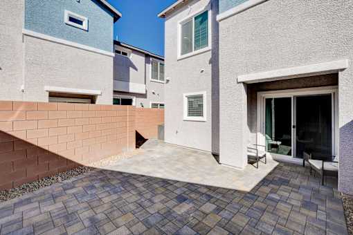 A modern house with a brick wall and a patio.at Copper Creek Apartments, Nevada