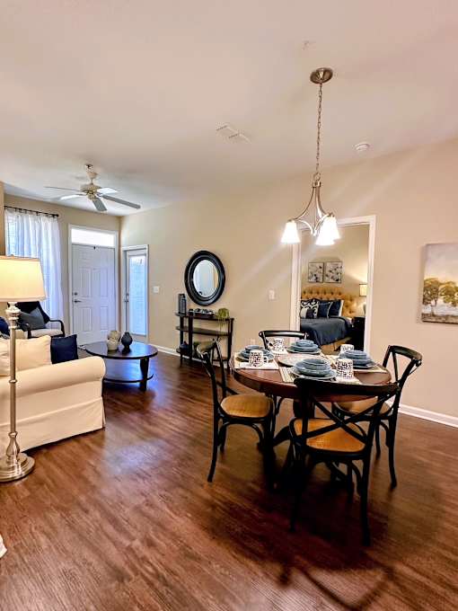 A dining room with a table set for six.