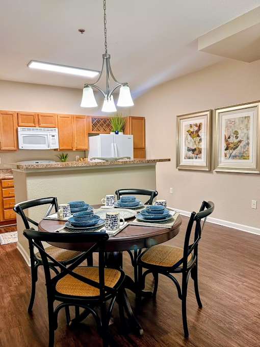 A dining room with a table set for two.