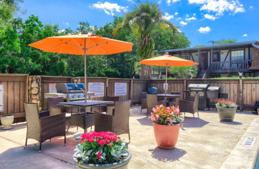 an outdoor patio with umbrellas and tables with chairs