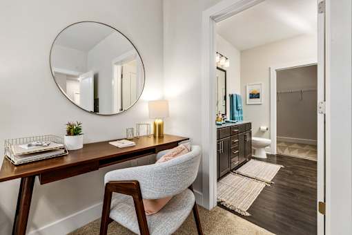A room with a desk and chair in it.