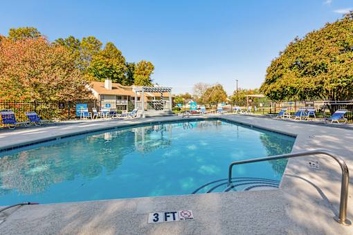A pool with a 3 feet sign on the edge.