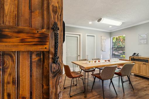 A wooden door with a metal handle is on the left side of the image.