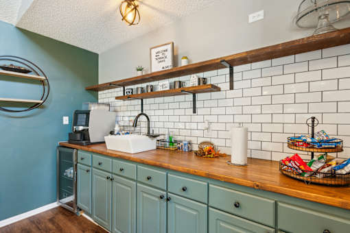 A kitchen with a blue wall and a wooden counter.