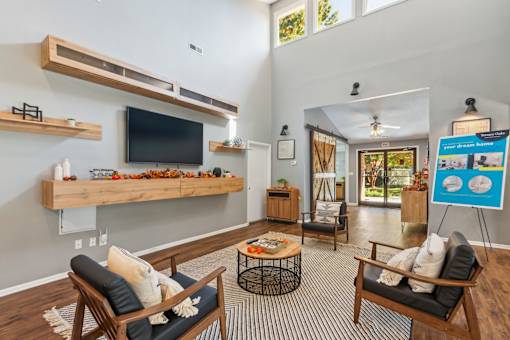 A living room with a television, a chair, and a table.