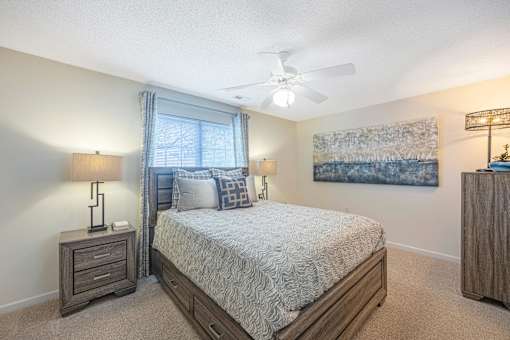 a bedroom with a bed and a ceiling fan