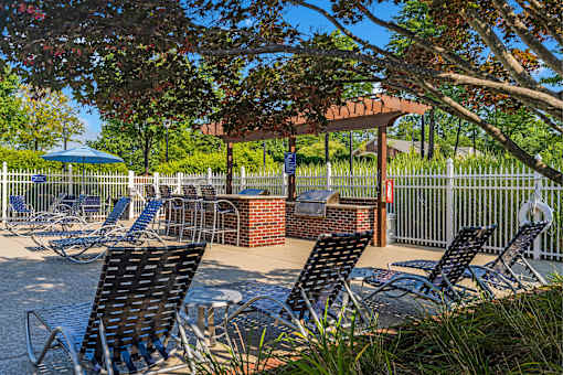 a patio with chairs and tables and a gazebo