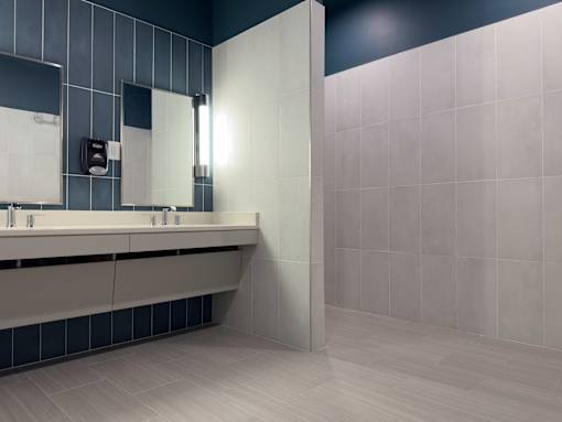 Myrtle Beach, SC, Luxury Apartments Near Tanger Outlets - Anchor Pointe - Bathroom With Double Sink Vanity, Large Wall Mirrors, and Tiled Shower Area.