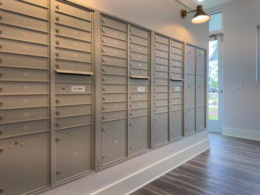 A row of mailboxes are lined up on a wall.