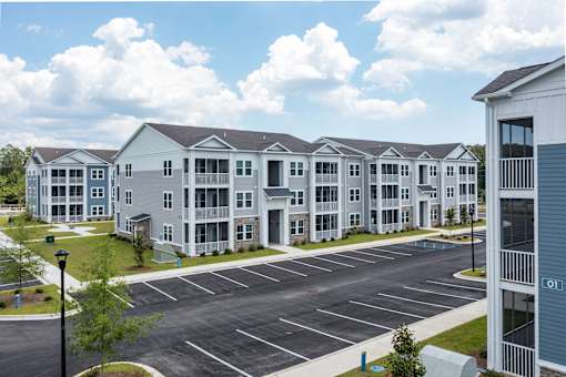 A large building with a parking lot in front of it.