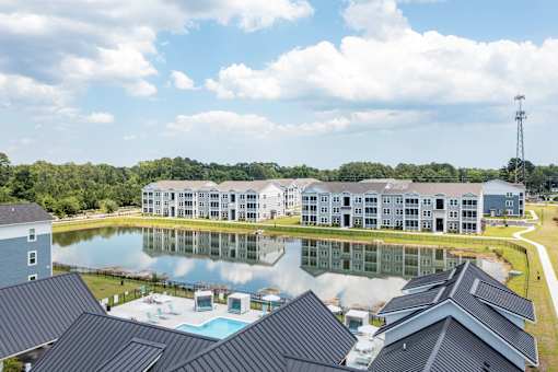 A large building with a pool in front of it.
