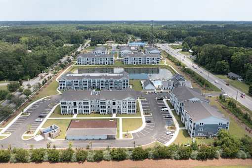 An aerial view of a large building complex surrounded by trees.