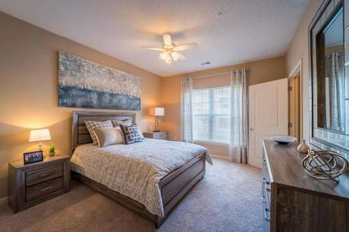 a bedroom with a bed and a ceiling fan