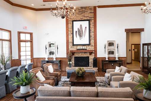 A living room with a fireplace and a chandelier.