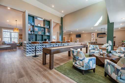 A large room with a long table and chairs.